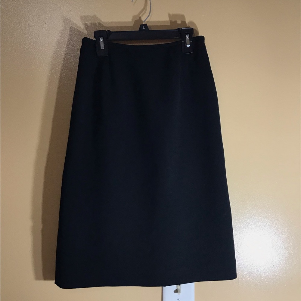 Solid black knee-length skirt.